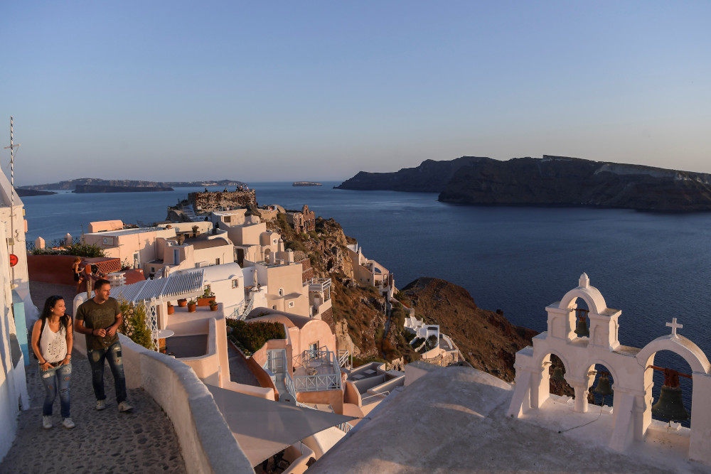 People walk in the empty alleys in the town of Oia in the island of Santorini June 14, 2020 as the country prepares for the return of tourists to Greece from around 30 countries by air, sea and land. u00e2u20acu201d AFP pic 