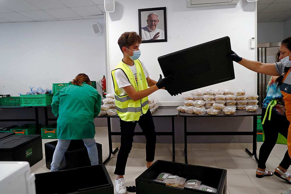 Volunteers organise donated food next to a photograph of Pope Francis at San Ramon Nonato Catholic parish amid the Covid-19 outbreak in Madrid, Spain June 2, 2020. u00e2u20acu201d Reuters pic