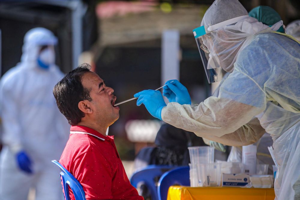 A man undergoes a swab test during a Covid-19 screening exercise in Taman Langat Utama June 3, 2020. u00e2u20acu201d Picture by Hari Anggara 