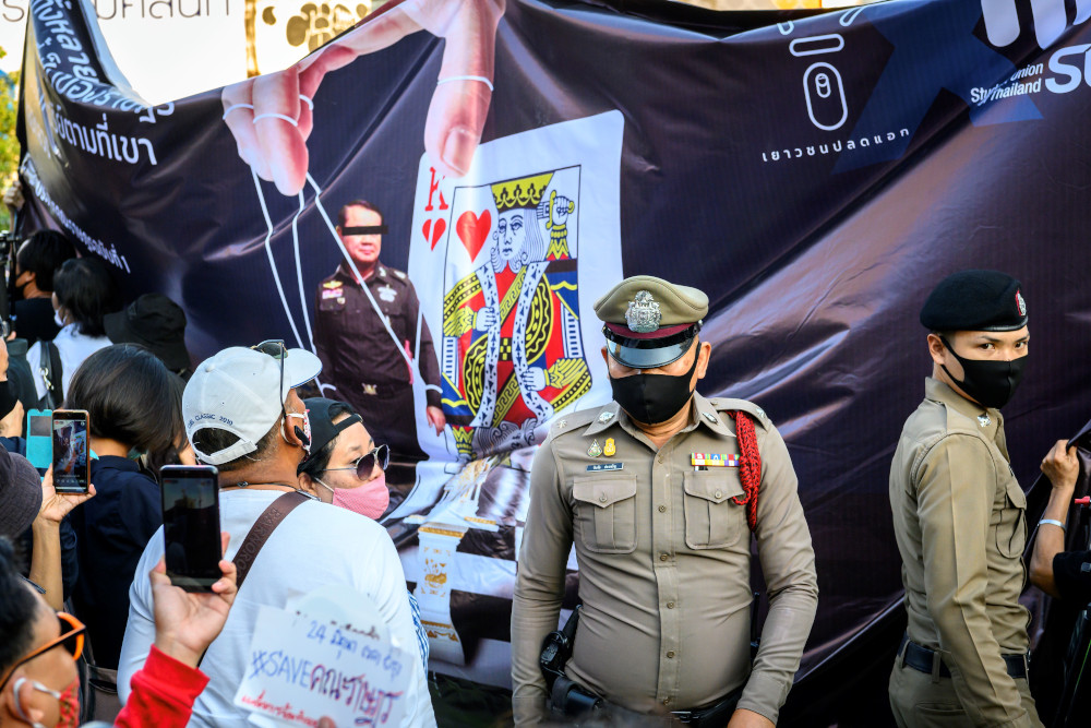 Policemen stand guard in front of a banner erected by pro-democracy activists during a commemoration of the anniversary of the 1932 revolution which ended absolute monarchy in Bangkok June 24, 2020. u00e2u20acu201d AFP pic 