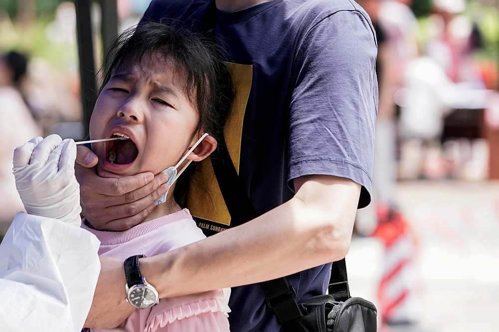 A child reacts while undergoing nucleic acid testing in Wuhan, the Chinese city hit hardest by the coronavirus disease Covid-19 outbreak, Hubei province, China May 16, 2020. u00e2u20acu201d Reuters picnn