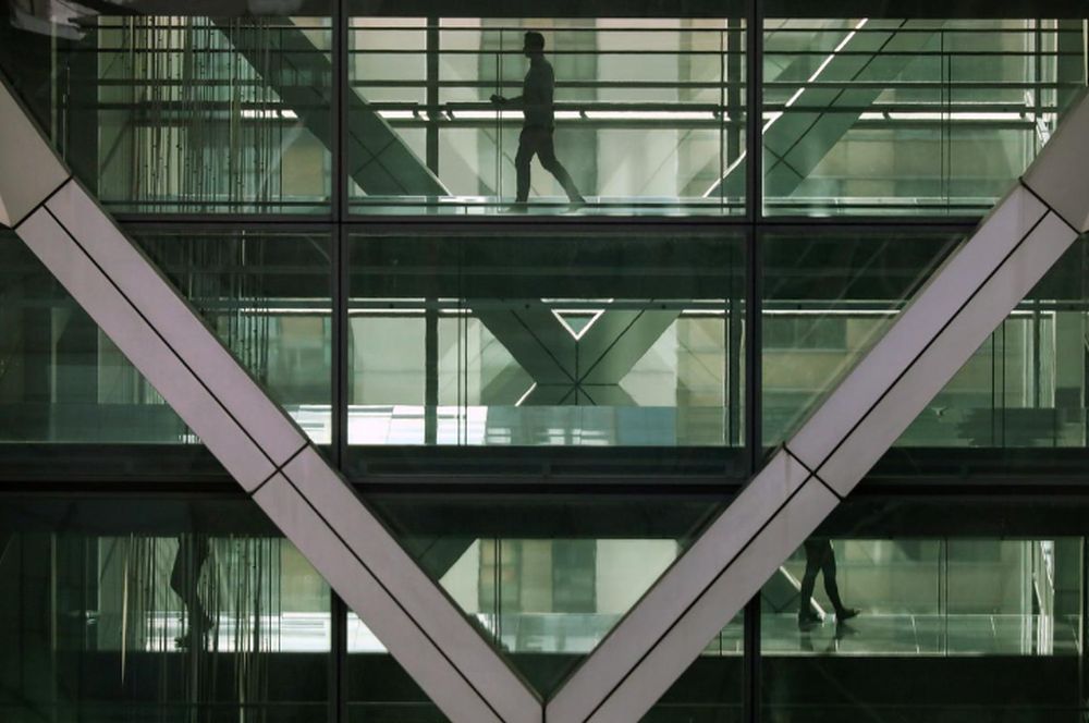 People walk in an office in the financial centre of Canary Wharf in London, Britain March 6, 2020. u00e2u20acu201d Reuters pic