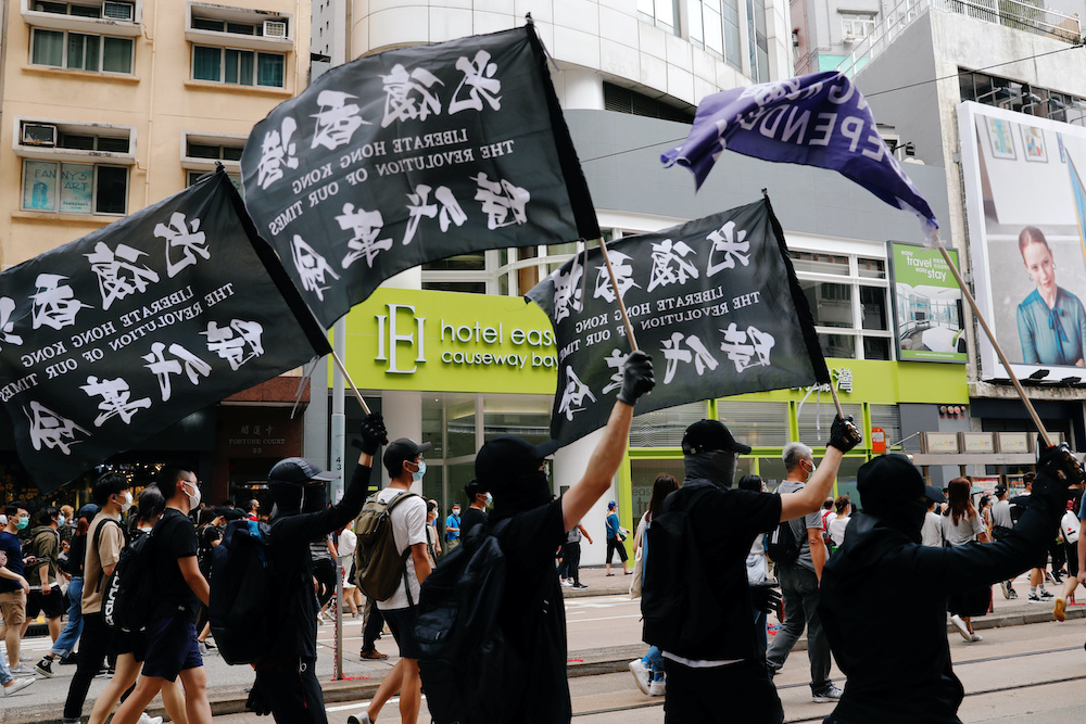 An anti-national security law protester holds a Hong Kong independence flag as he marches at the anniversary of Hong Kong's handover to China from Britain in Hong Kong, China July 1, 2020. u00e2u20acu201d Reuters pic