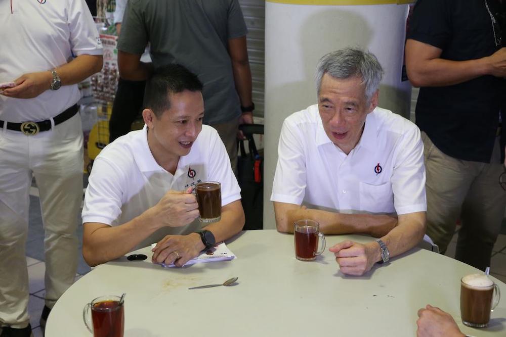 Lee Hsien Loong and Yip Hon Weng did not address the media, but sat down together to chat about the new candidateu00e2u20acu2122s campaign so far, talking over coffee and tea served by one of the stalls. u00e2u20acu201d TODAY pic