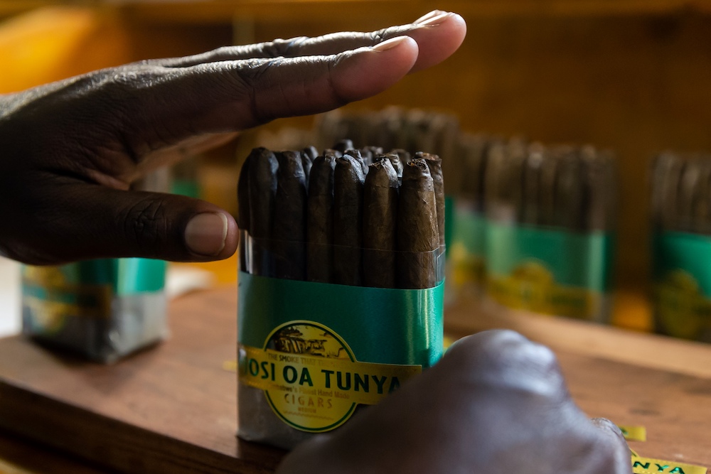 A woman packages freshly packed and labelled rolled cigars at the Mosi Oa Tunya, the first cigar manufacturing plant in Zimbabwe, in Harare on June 25, 2020. u00e2u20acu201d AFP pic