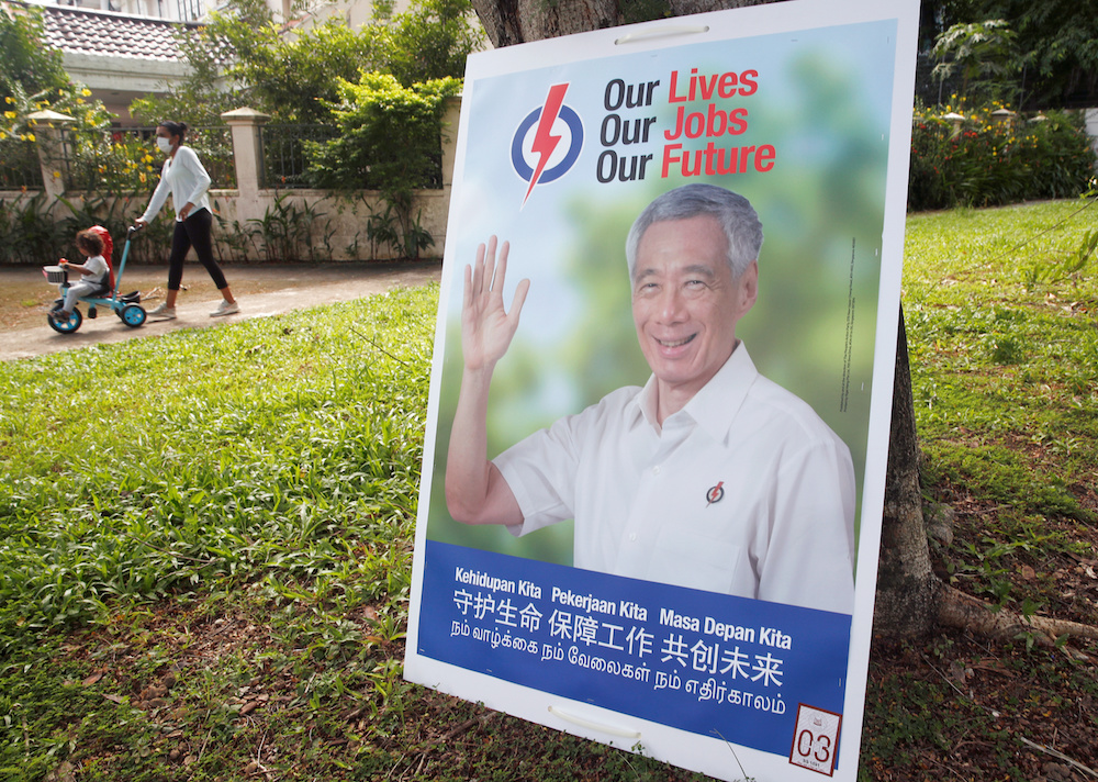 A woman and a child pass by an electoral poster ahead of the general election in Singapore June 30, 2020. u00e2u20acu201d Reuters pic