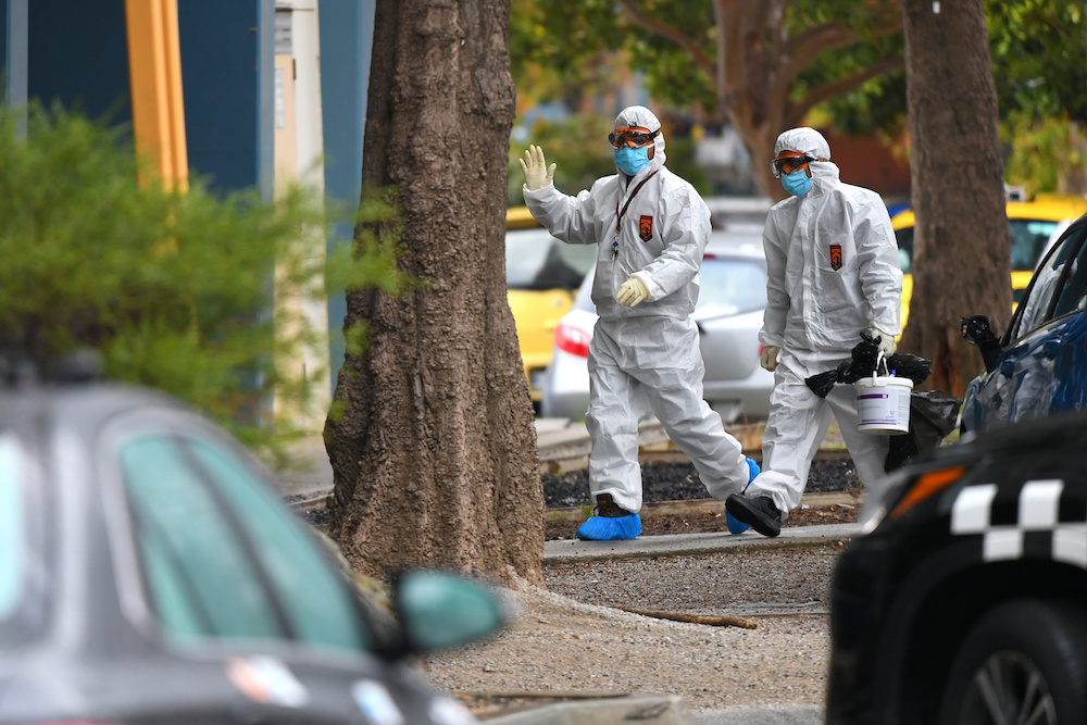 People in hazardous material overalls are seen outside of a public housing tower along Racecourse Road that was placed under lockdown due to the Covid-19 outbreak in Melbourne July 6, 2020. u00e2u20acu201d AAP Image/James Ross handout via Reuters