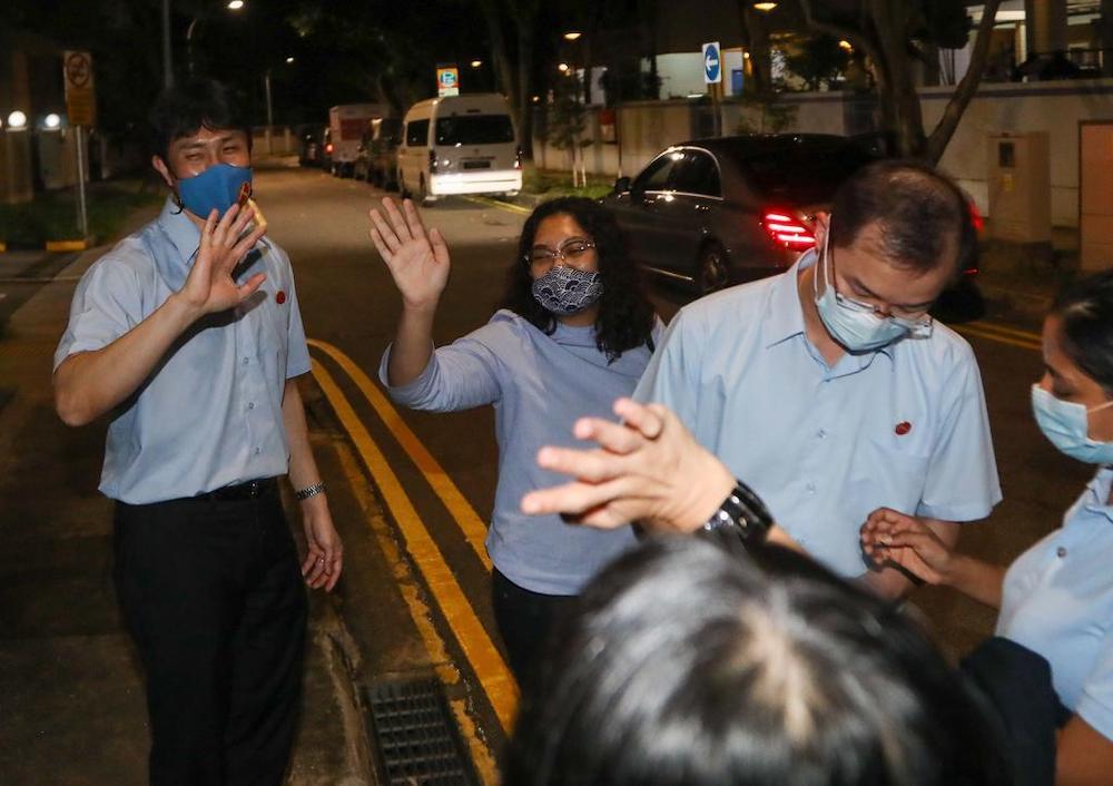 Dr Jamus Lim, Raeesah Khan and Chua Kheng Wee thanking party volunteers after leaving the Workersu00e2u20acu2122 Party headquarters in Geylang July 11, 2020. u00e2u20acu201d TODAY pic