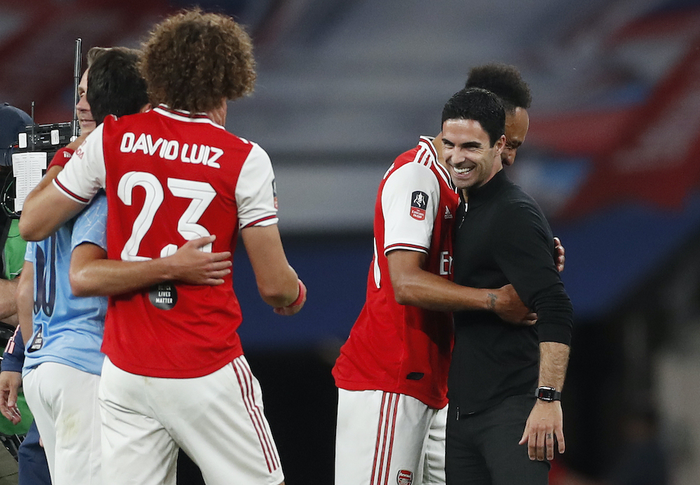 Arsenal's Pierre-Emerick Aubameyang, David Luiz and manager Mikel Arteta celebrate after the match, July 18, 2020. u00e2u20acu201d Matthew Childs / Pool handout via Reuters