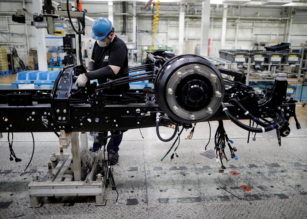 An employee wearing a protective face mask and face guard works on the automobile assembly line at Kawasaki factory of Mitsubishi Fuso Truck and Bus Corp May 18, 2020. u00e2u20acu201d Reuters pic