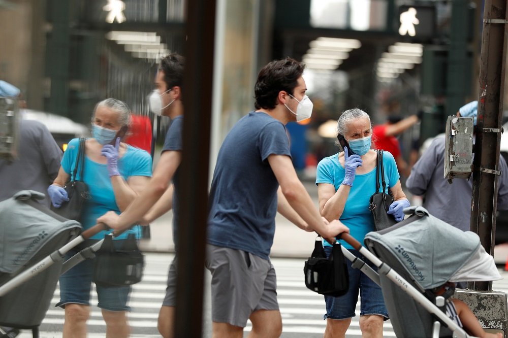 Pedestrians wearing masks walk down the sidewalk in the Manhattan borough of New York July 1, 2020. u00e2u20acu201d Reuters pic