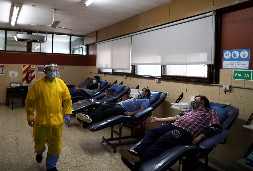 A health care worker walks past blood donators at the Hemotherapy Institute in La Plata, during the spread of the coronavirus disease, Argentina June 30, 2020. u00e2u20acu201d Reuters pic