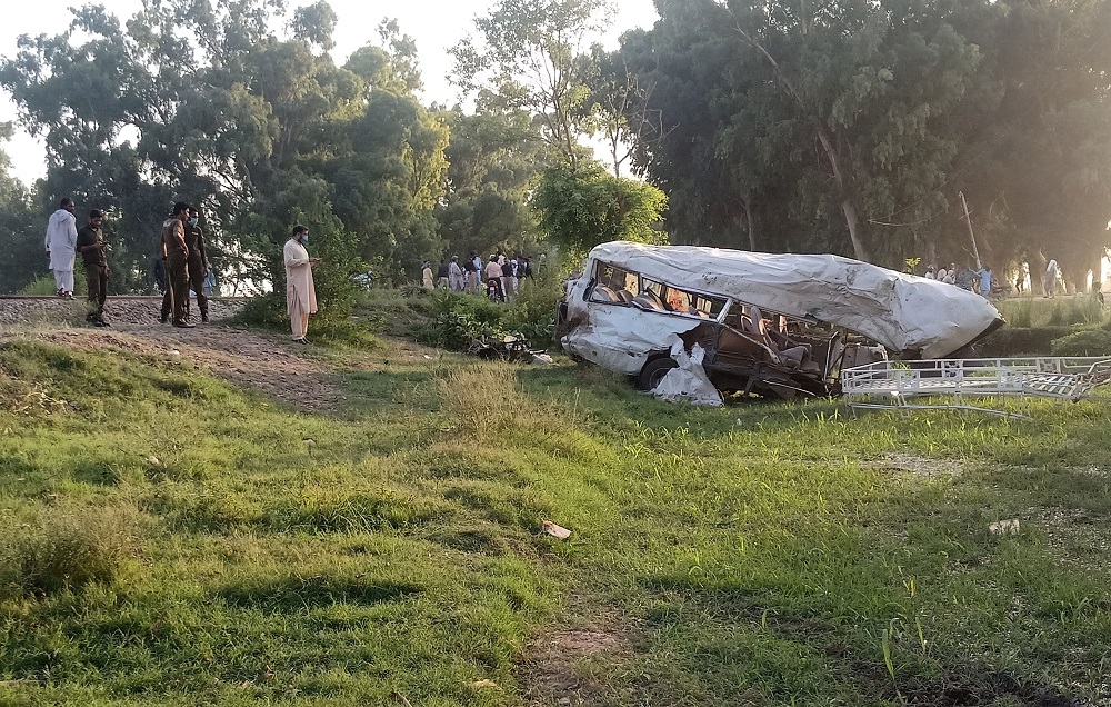 Police officers and residents gather near the wreckage after a train collided with a passenger van in Sheikhupura, Pakistan July 3, 2020. u00e2u20acu201d Reuters pic