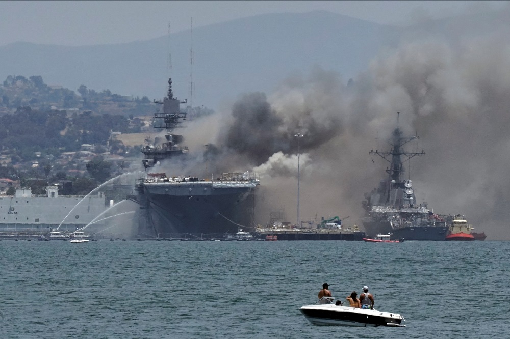 Firefighting boats spray water onto the US Navy amphibious assault ship USS Bonhomme Richard as smoke rises from a fire on board the ship at Naval Base San Diego, as seen from Coronado, California July 12, 2020. u00e2u20acu201d Reuters pic