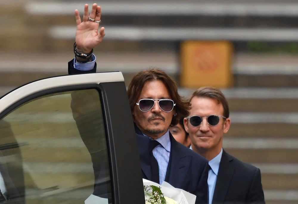 Actor Johnny Depp waves as he leaves the High Court in London July 14, 2020. u00e2u20acu201d Reuters pic