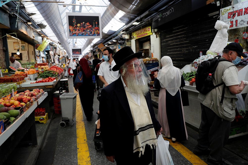 People wear face masks as they shop in a main market in Jerusalem July 16, 2020. u00e2u20acu201d Reuters pic