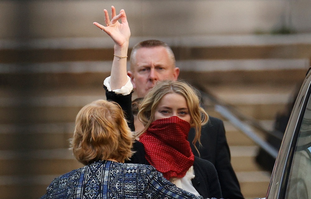 Actor Amber Heard waves as she leaves the High Court in London July 17, 2020. u00e2u20acu201d Reuters pic