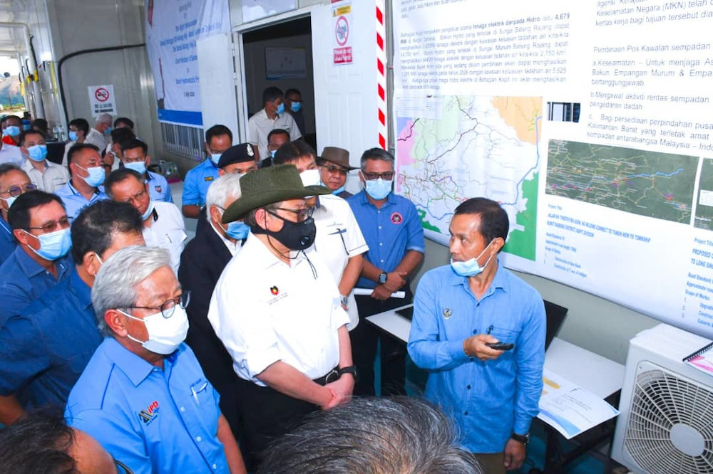 Sarawak Chief Minister Datuk Patinggi Abang Johari Openg (wearing dark face mask) is briefed on the construction progress of the Baleh dam during a site visit on July 7, 2020. u00e2u20acu201d Picture courtesy of the Chief Ministeru00e2u20acu2122s Office 
