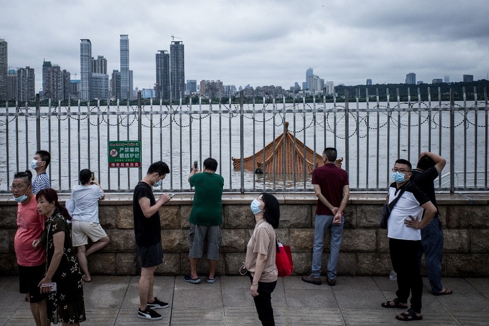 Residents stand before an inundated pavilion in the swollen Yangtze River in Wuhan in Chinau00e2u20acu2122s central Hubei province July 12, 2020. u00e2u20acu201d AFP pic