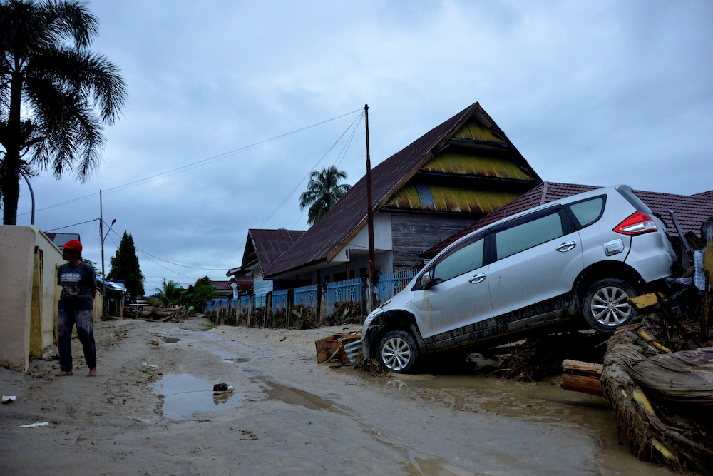 A car is partially covered in mud after flash floods swept through the village of Radda, as several people were killed and dozens remain missing in North Luwu, South Sulawesi, Indonesia July 15, 2020. u00e2u20acu201d Reuters pic