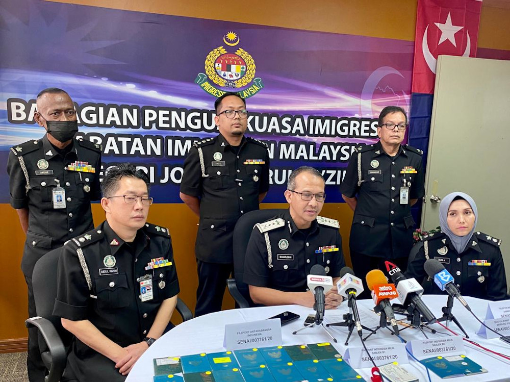 Johor Immigration director Baharuddin Tahir (centre) said the possibility of an u00e2u20acu02dcinsideru00e2u20acu2122 was based on the suspect having competency in computer technology and in-depth knowledge of the departmentu00e2u20acu2122s internal system July 20, 2020. u00e2u20acu201d Picture by Ben 