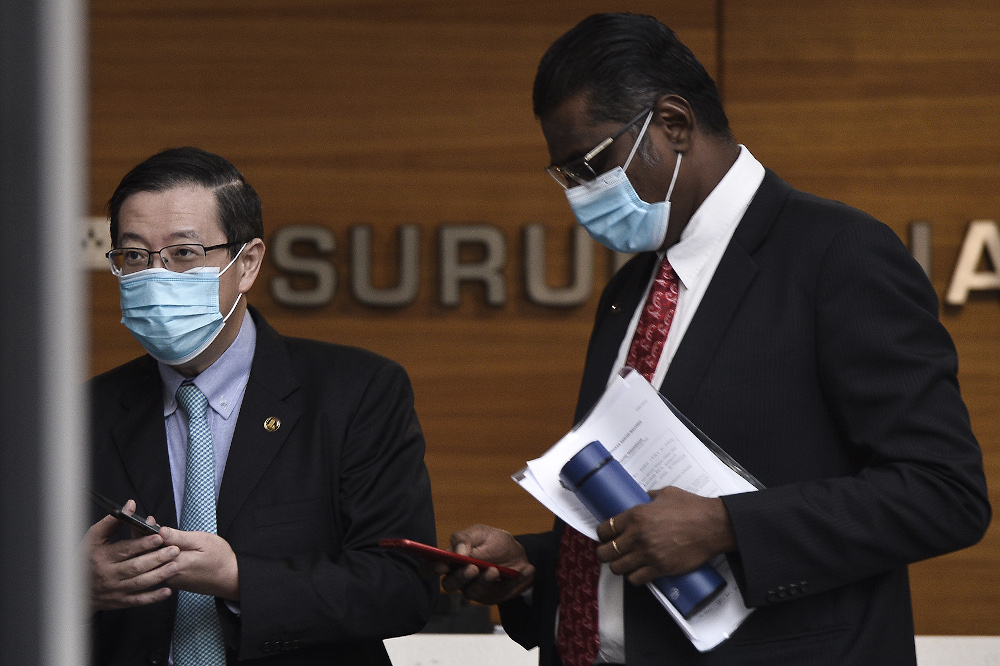 Former finance minister Lim Guan Eng and his lawyer RSN Rayer leave MACC in Putrajaya July 22, 2020. — Picture by Miera Zulyana