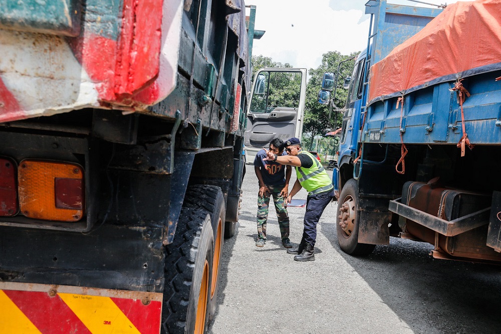 A Road Transport Department officer inspects a lorry at the Road Transport Department Enforcement Station in Penaga July 23, 2020. Picture by Sayuti Zainudin