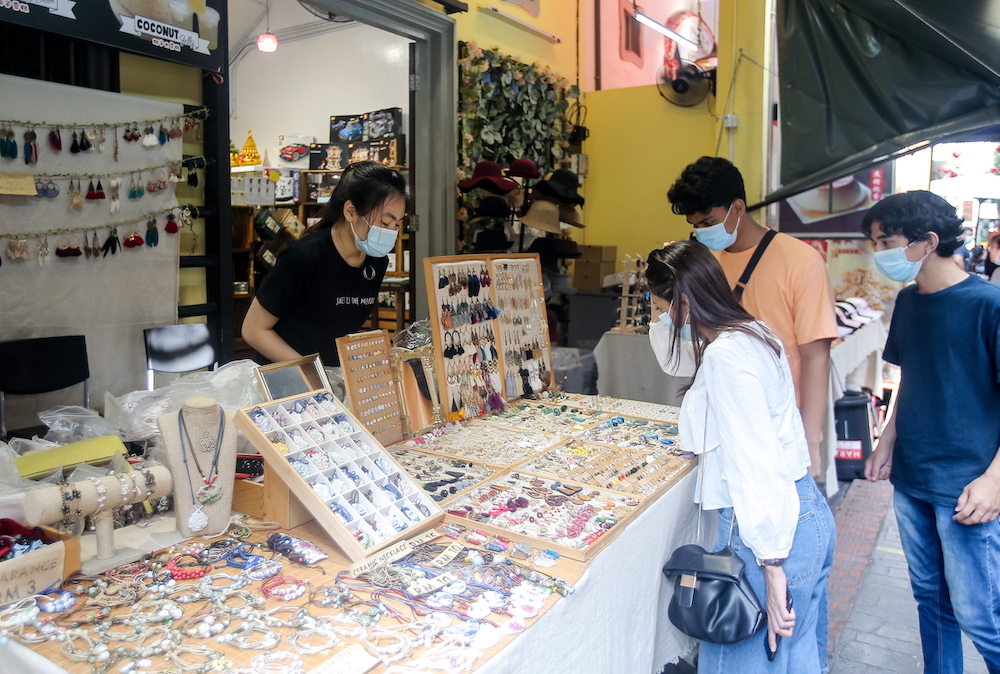 Loh Pui Wee, 18, a souvenir shopkeeper on Ipoh’s Concubine Lane said that more local tourists are visiting the Ipoh Old Town area. — Picture by Farhan Najib