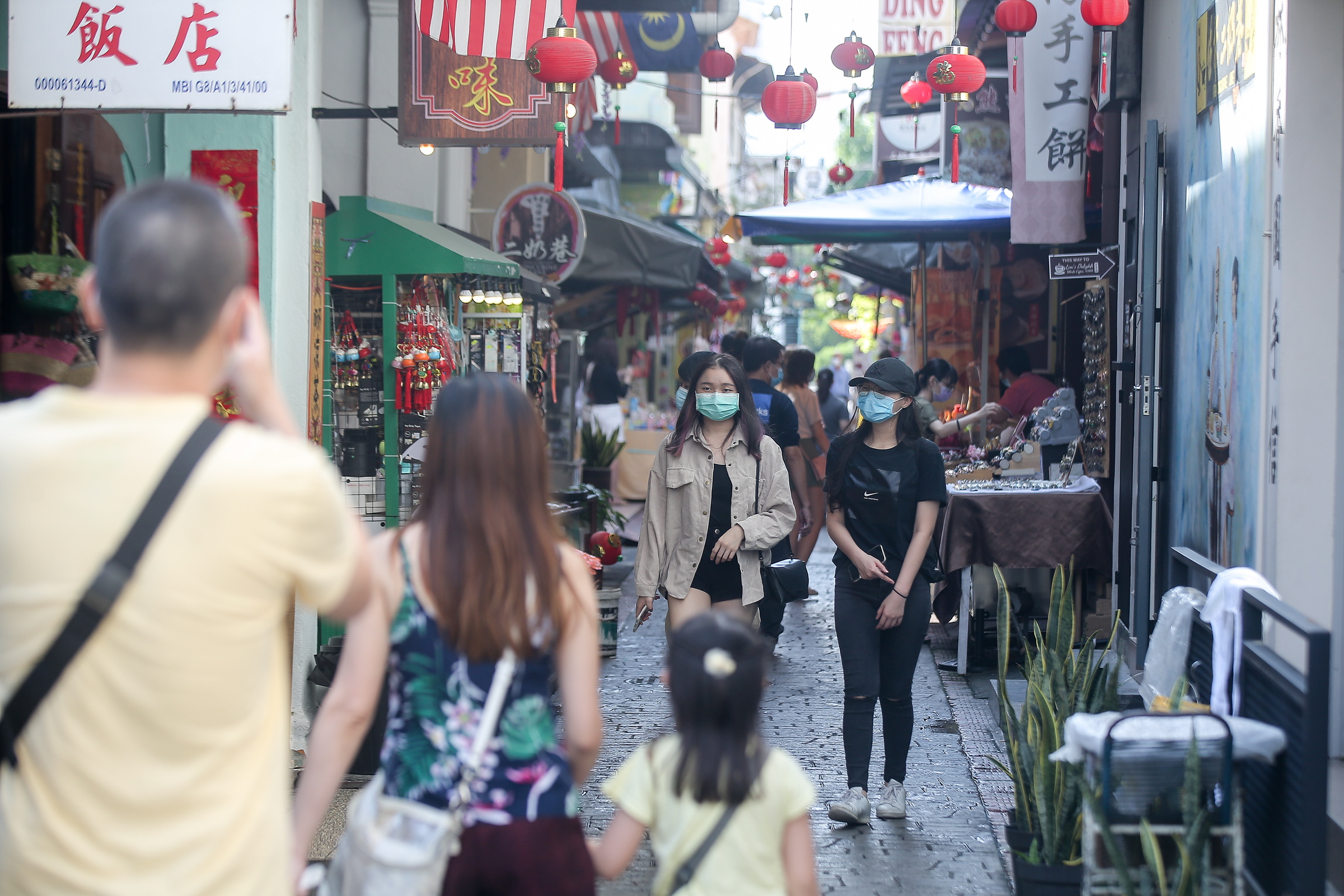 Domestic tourists visit Ipoh’s Concubine Lane.  After months of lockdown due to the Covid-19 pandemic, Ipoh Town is gradually returning to its lively bustling atmosphere as tourist spots attract domestic tourists. — Picture by Farhan Najib