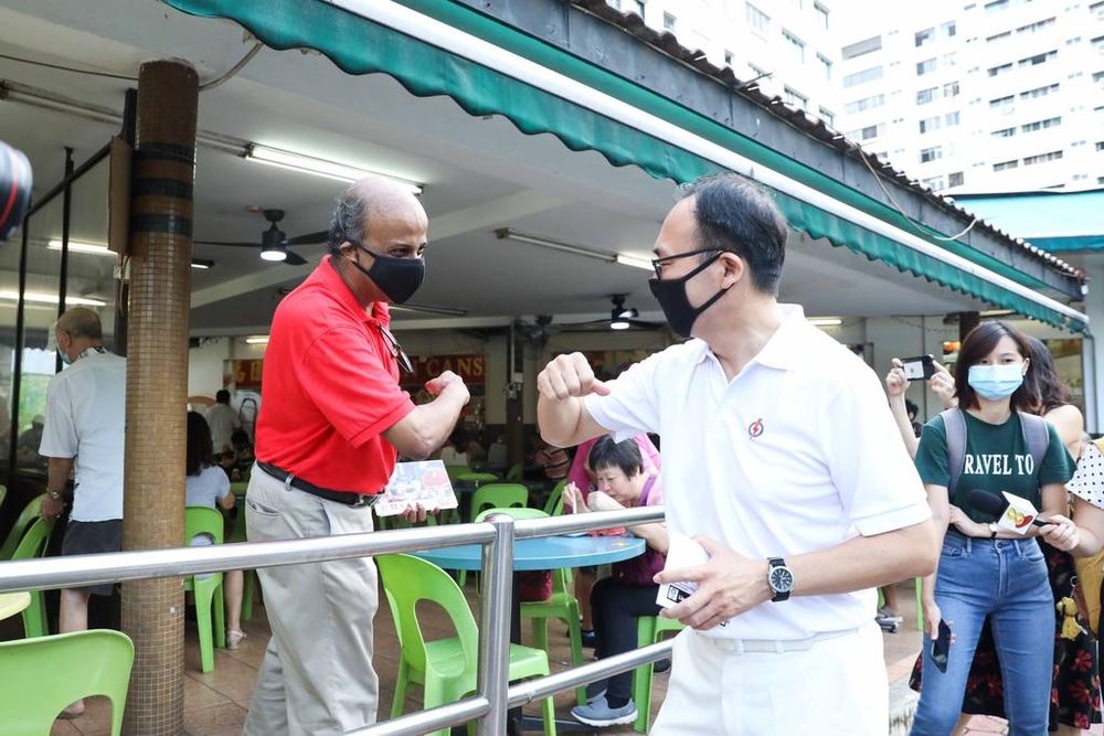 Singapore Democratic Partyu00e2u20acu2122s candidate for Bukit Panjang SMC, Dr Paul Tambyah, bumped into Liang Eng Hwa during a walkabout on July 1, 2020. u00e2u20acu201d TODAY pic