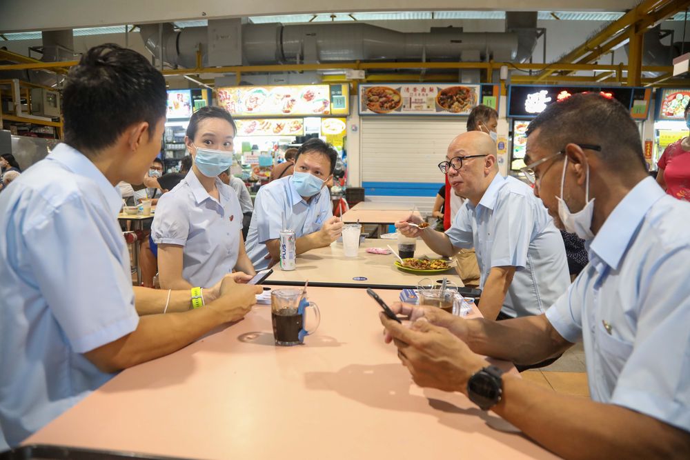 The Workers’ Party team contesting East Coast GRC taking a break during a walkabout at a hawker centre in Bedok North on July 1, 2020. — TODAY pic