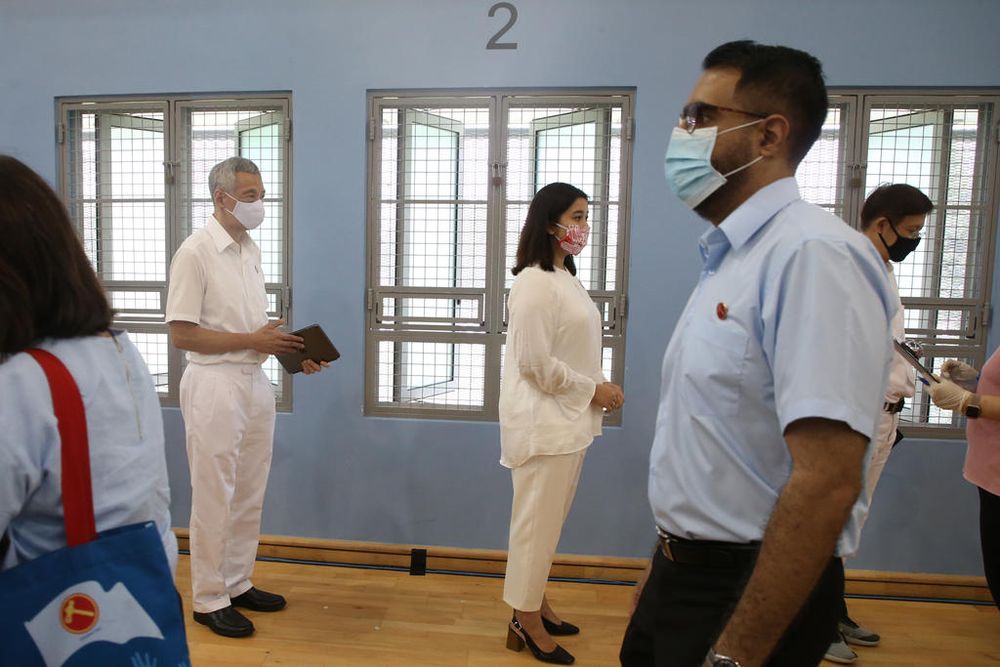 Pritam Singh walks past Prime Minister Lee Hsien Loong after delivering a speech at Deyi school on Nomination Day, June 30, 2020. u00e2u20acu201d TODAY pic
