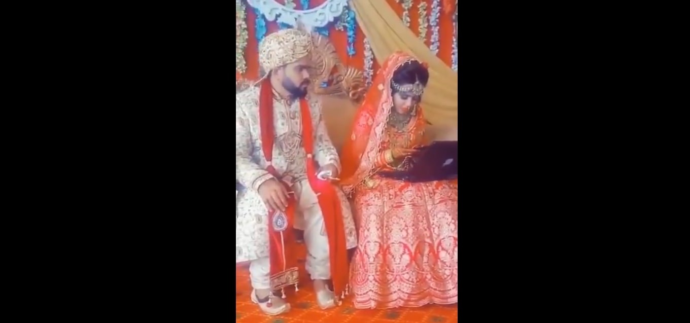 Screencap of bride occupied with her gadgets at her wedding.  u00e2u20acu201dTwitter/@dineshjoshi70 pic