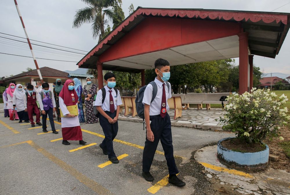 Sekolah Kebangsaan Jelapang students observe social distancing on their first day back at school in Ipoh July 15, 2020. u00e2u20acu201d Picture by Farhan Najib