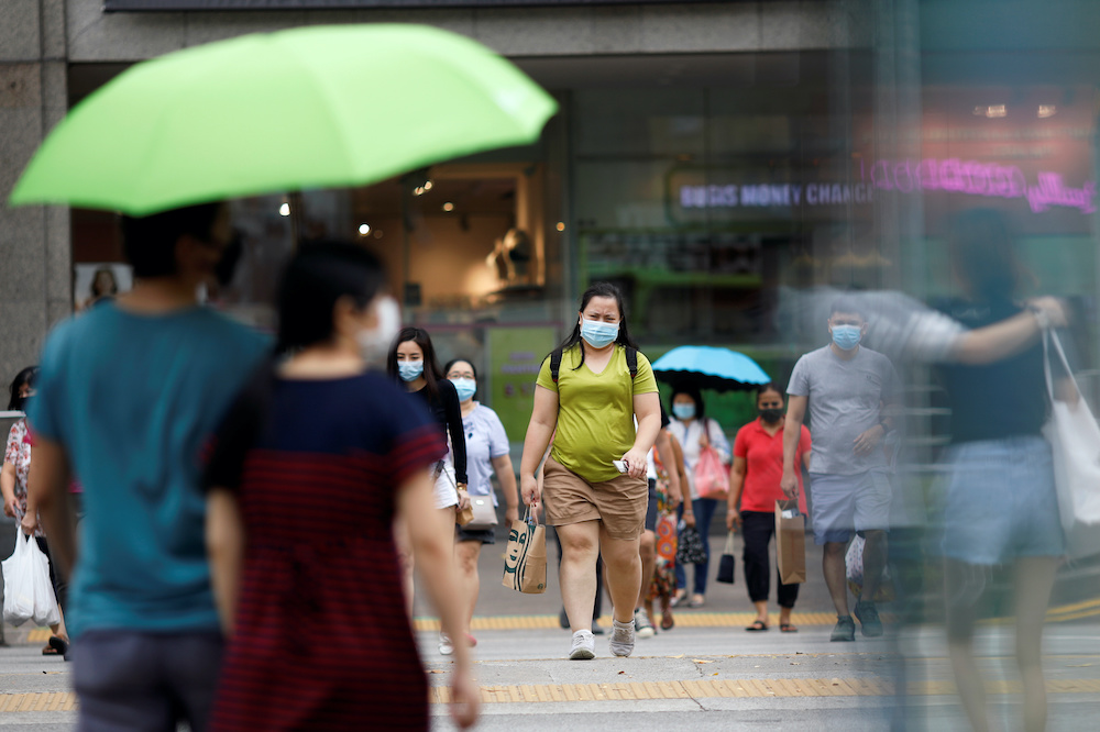 People wearing protective face masks cross a street, amid the coronavirus disease outbreak, in Singapore July 14, 2020. u00e2u20acu201d Reuters picnn