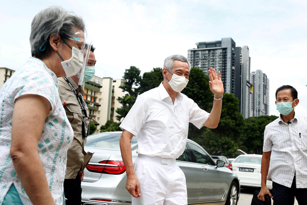 Singaporeu00e2u20acu2122s Prime Minister Lee Hsien Loong and his wife Ho Ching at a polling station during Singaporeu00e2u20acu2122s general election, amid the coronavirus disease outbreak, in Singapore July 10, 2020. u00e2u20acu201d AFP pic