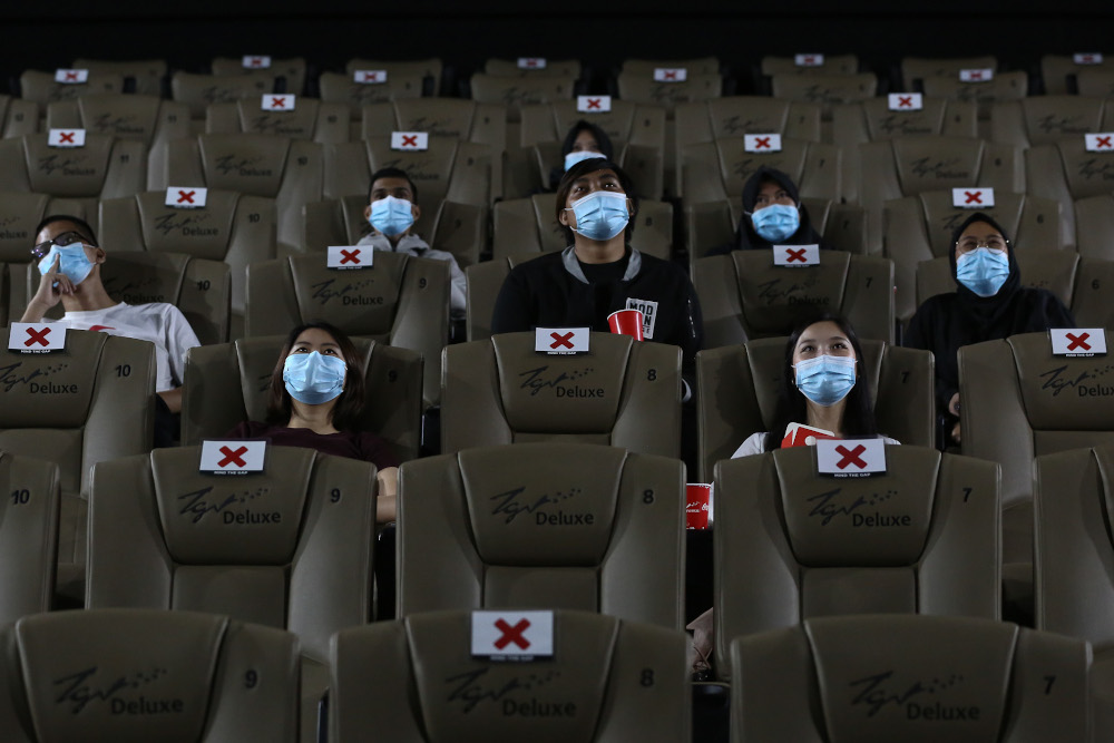 People wearing protective face masks sit while social distancing before watching a movie at a TGV cinema in Central I-City, Shah Alam July 1, 2020. u00e2u20acu201d Picture by Yusof Mat Isa