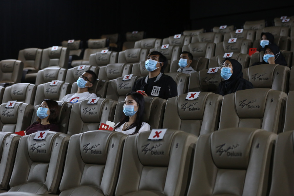 People wearing protective face masks sit while social distancing before watching a movie at a TGV cinema in Central I-City, Shah Alam July 1, 2020. u00e2u20acu201d Picture by Yusof Mat Isa
