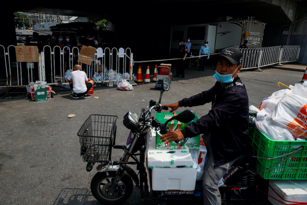 File photo of a delivery rider bringing food to the barrier surrounding a residential area near the Xinfadi market that has been placed under lockdown after a new outbreak of the coronavirus disease in Beijing, China June 20, 2020. u00e2u20acu201d Reuters picnnn