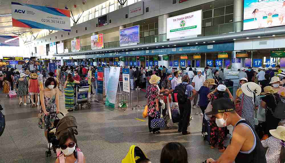 Tourists wear protective masks as they wait to check-in for departure at Da Nang Airport, Vietnam July 26, 2020. u00e2u20acu201d VNA pic via Reuters