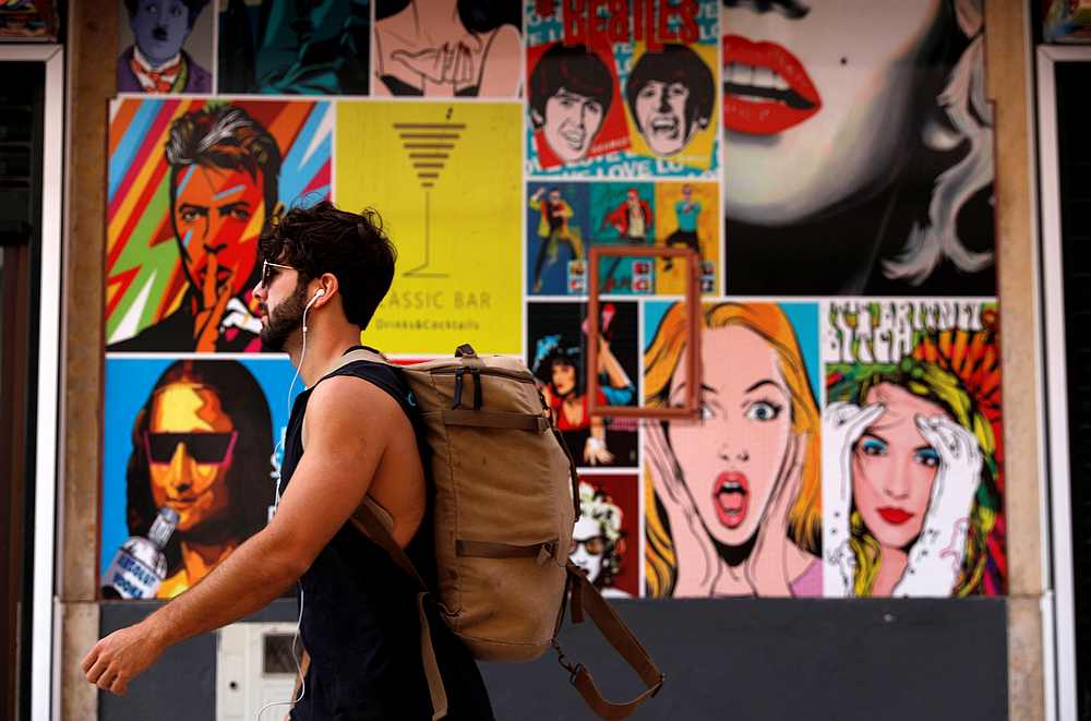 A tourist walks next to a pub during the Covid-19 pandemic in downtown Albufeira, Portugal July 21, 2020. u00e2u20acu201d Reuters pic