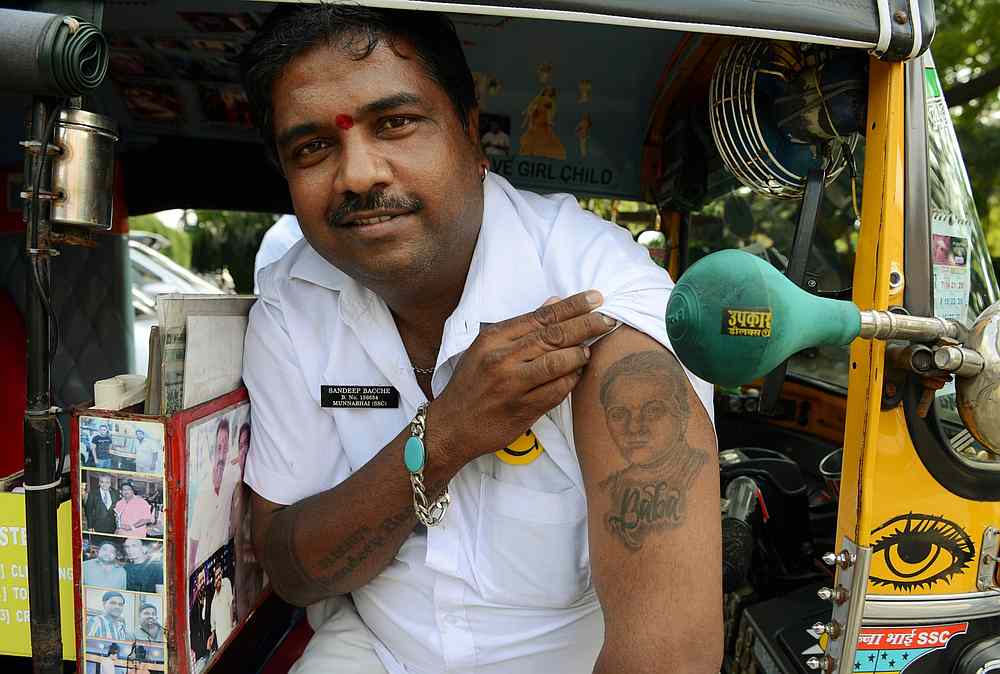 Sandeep Bacche, an Indian rickshaw driver and fan of Bollywood actor Sanjay Dutt, poses for a picture in Mumbai. u00e2u20acu201d AFP pic