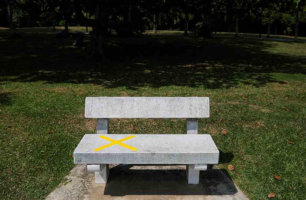 A bench marked out with tape to encourage physical distancing is pictured at a park in Singapore on April 1, 2020. u00e2u20acu201d Reuters pic 