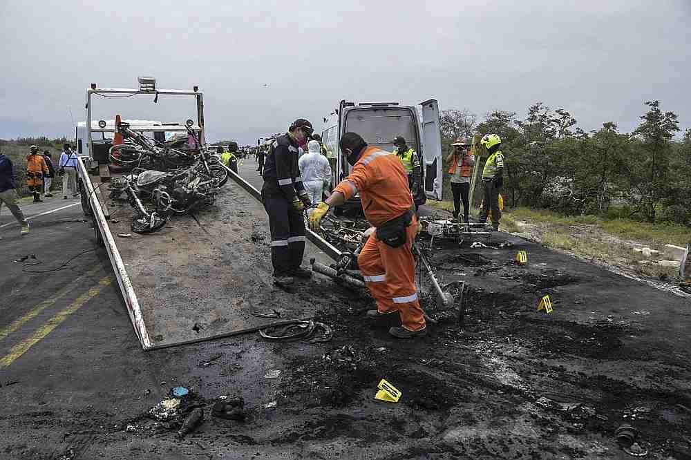 A firefighter removing the remains of a tanker truck carrying fuel that caught fire in Pueblo Viejo, north of Bogota, Colombia July 6, 2020.  u00e2u20acu201d Gobernacion de Magdalena handout via AFP 