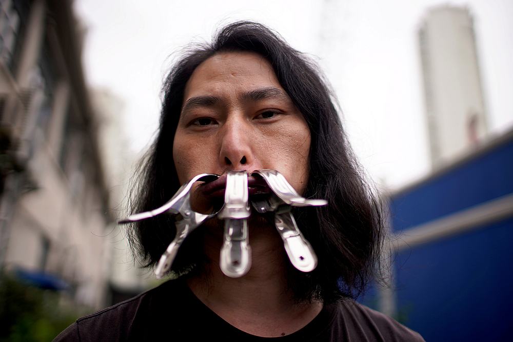 Brother Nut, Chinese performance artist with three metallic clips sealing his mouth, poses for a picture in Shanghai, China July 13, 2020. u00e2u20acu201d Reuters pic