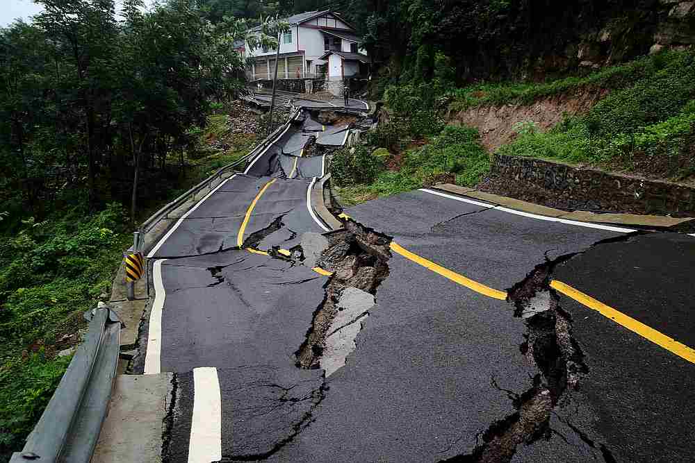 A road damaged by a landslide following heavy rainfall in Chongqing's Qianjiang district, China July 4, 2020. Another landslide in Hebei province has buried nine people July 8, 2020. u00e2u20acu201d China Daily pic via Reuters