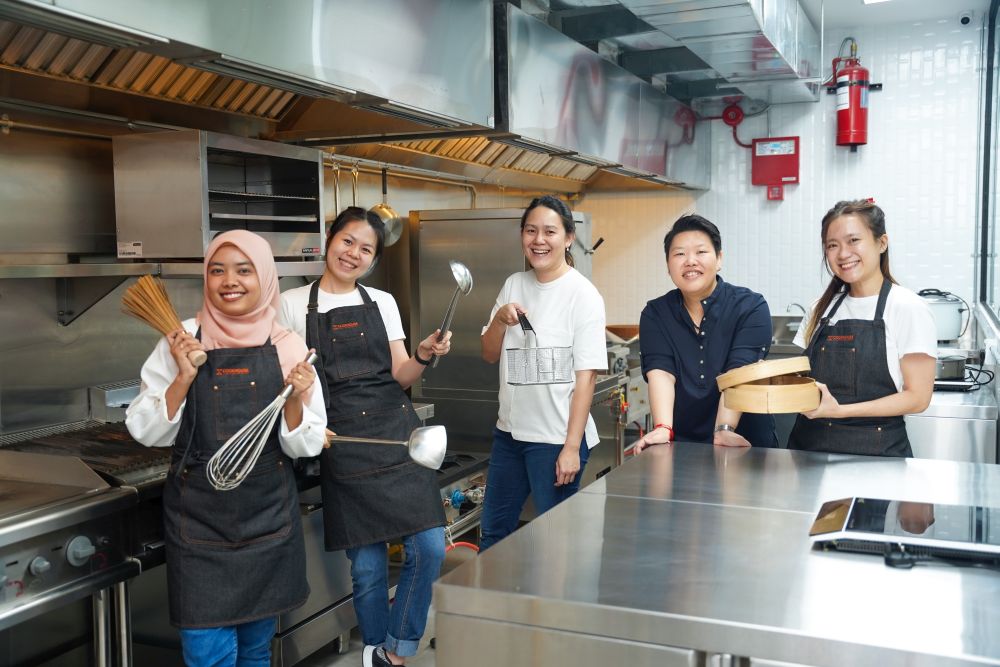 Cookhouse founder Huen Su San (second from right) used her experience of setting up two central kitchens and an event space to give her new venture an edge. — Picture courtesy of Cookhouse