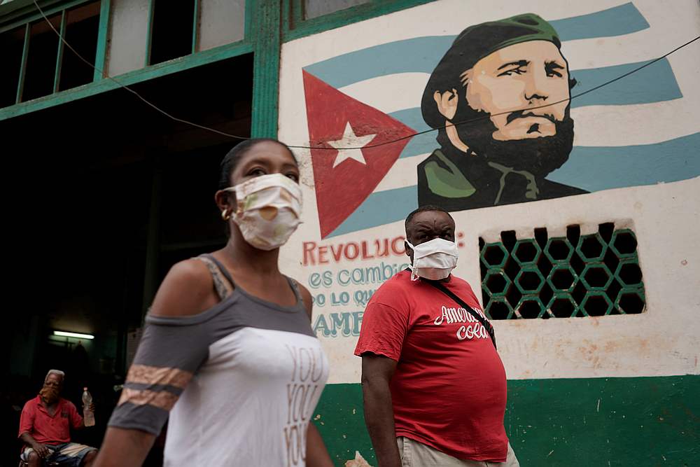 People pass by an image of late Cuban President Fidel Castro amid concerns about the spread of Covid-19, in Havana, Cuba July 19, 2020. u00e2u20acu201d Reuters pic
