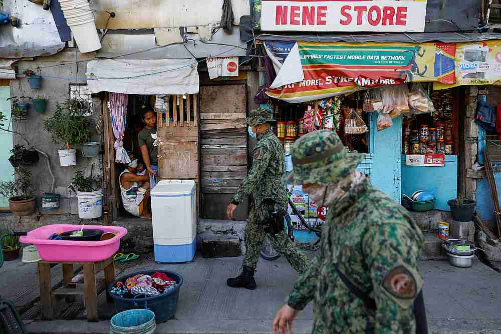 Police officers patrol a neighbourhood to enforce the reimposed lockdown due to a spike in the Covid-19 cases, in Manila, Philippines July 17, 2020.  u00e2u20acu201d Reuters 