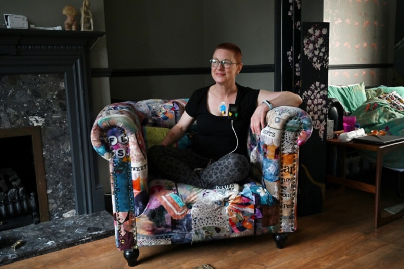 British forensic psychiatrist Jenny Judge who is a long-term sufferer with post-coronavirus symptoms, wears a heart monitor as she poses at her home in West Ewell, Surrey, southeast England. u00e2u20acu2022 AFP pic